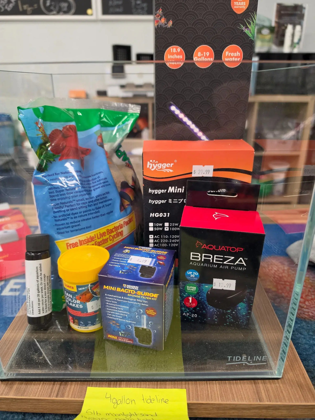 Tideline 4.1 gallon aquarium starter bundle on store display with sand, Hygger light, 25W heater option, air pump, sponge filter and food